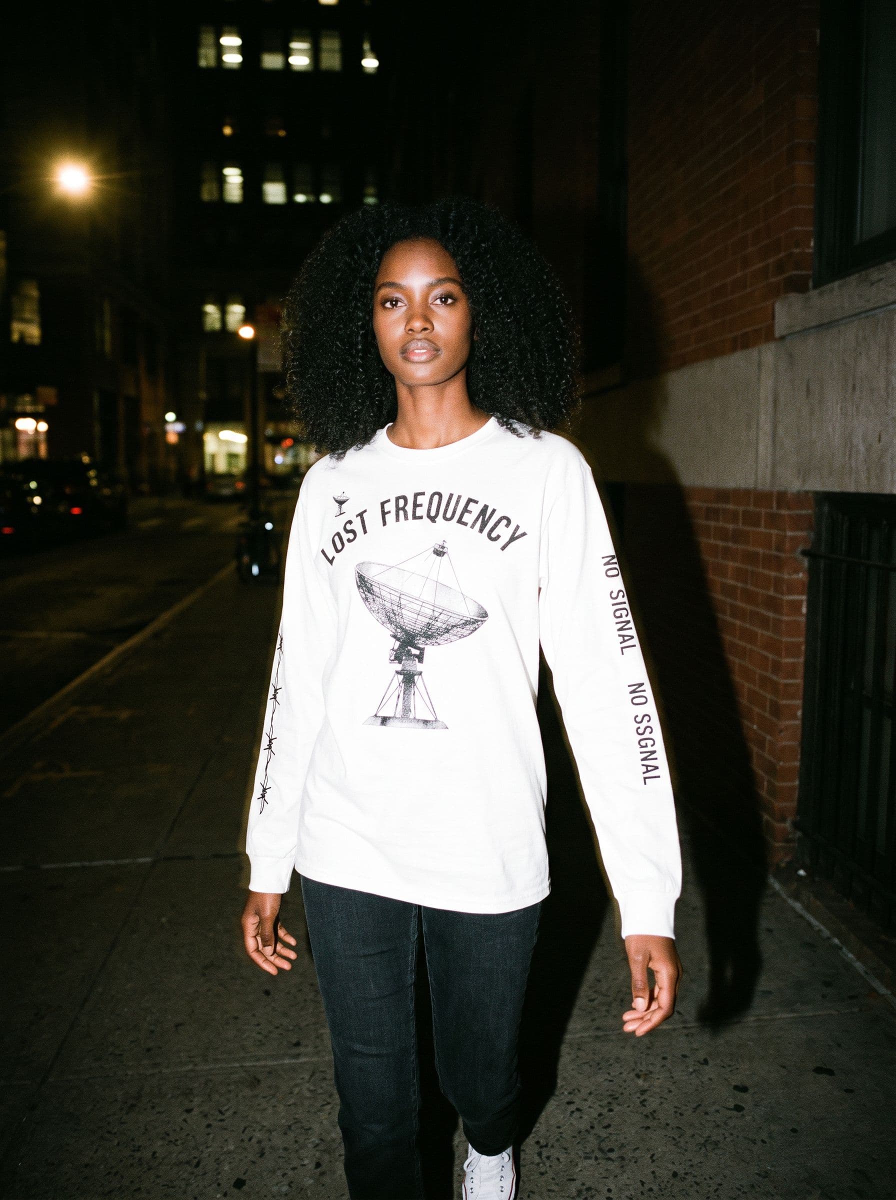 AI model photo of the lost frequency long-sleeve — flash photo on house model amara, generated by unworn